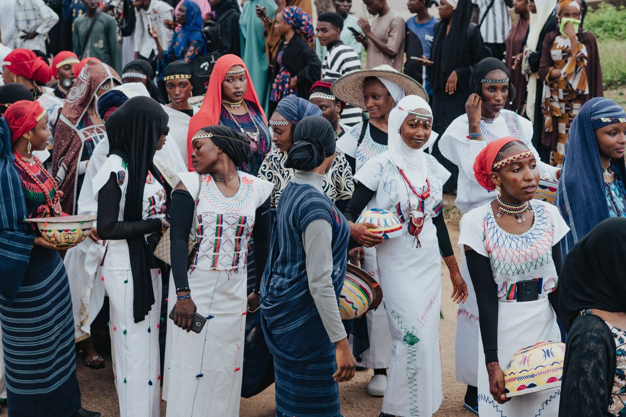 Vibrant gathering of African women in traditional attire during a cultural festival.